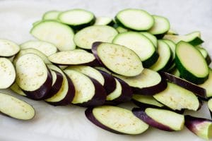 sliced eggplant and zucchini on a cutting board