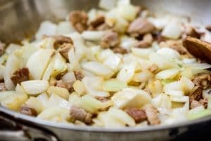Stir-frying pork and onion for Korean black bean noodles