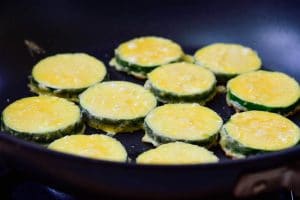 pan-frying flour and egg battered zucchinis