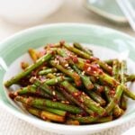 red spicy garlic scapes in a small bowl with light green trim