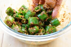 mixing chili pepper pieces with a doenjang sauce