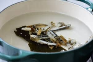 making anchovy broth in a pot