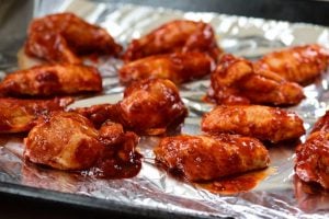 red spicy chicken wings in a baking tray for baking