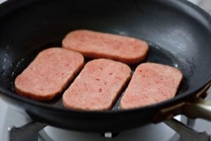 Cooking thin slices of Spam in a pan