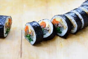 cutting a kimbap roll into slices
