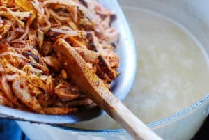 Adding seasoned turkey to the soup