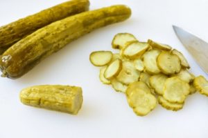 Korean cucumber pickle being cut into thin slices