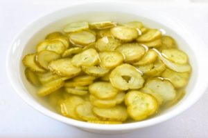 Korean pickled cucumber slices being soaked in water