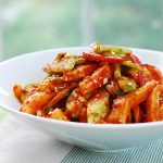 Red spicy Korean squid salad in a bowl